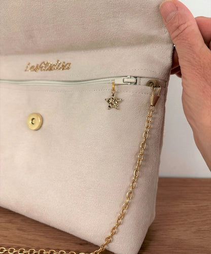 La fermeture éclair de la pochette Isa zippée ivoire et dorée.