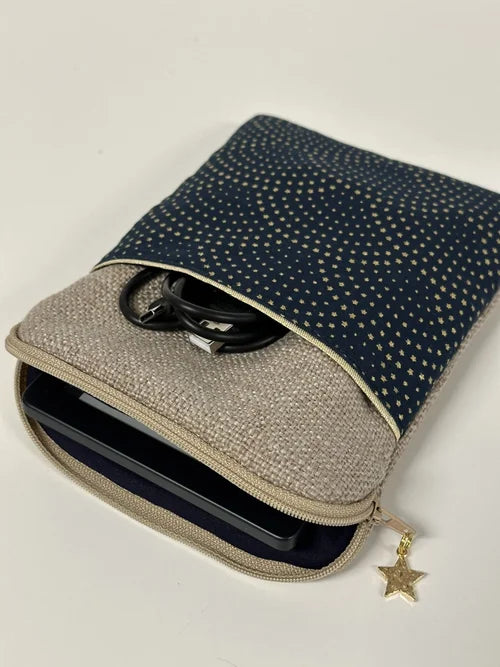 La pochette liseuse en lin et tissu bleu à étoiles dorées, ouverte.
