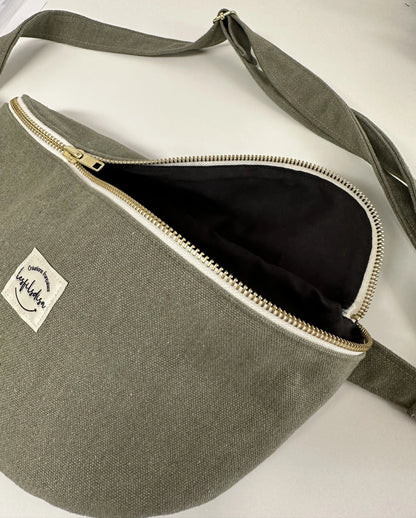 Le sac banane en toile vert kaki, ouvert.