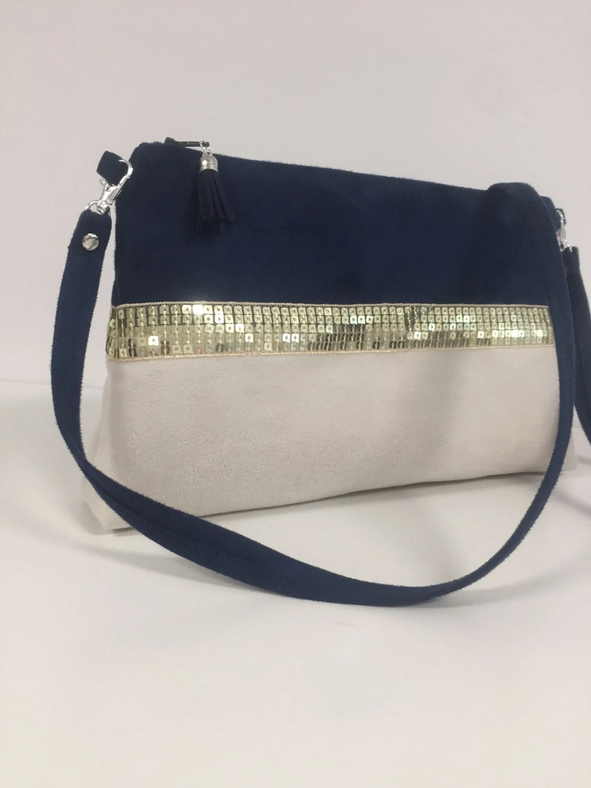 Vue d'ensemble du sac bandoulière Isa bleu marine et ivoire à paillettes dorées.