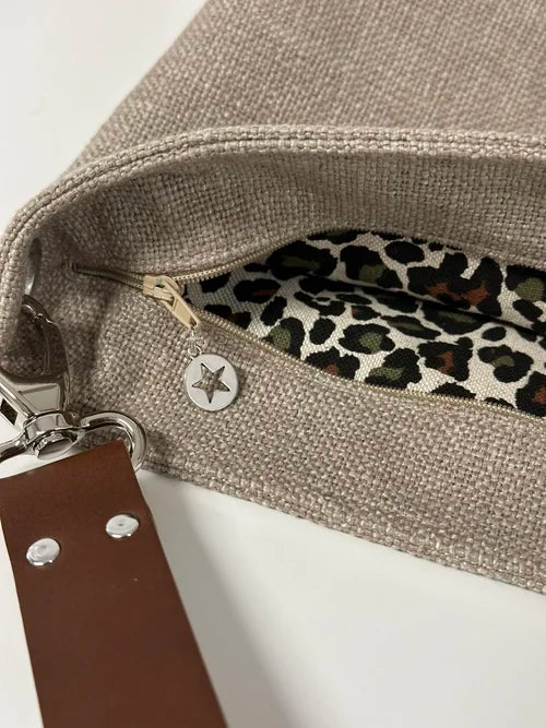 Le sac Hobo en lin beige et léopard avec anse en cuir marron, avec fermeture éclair