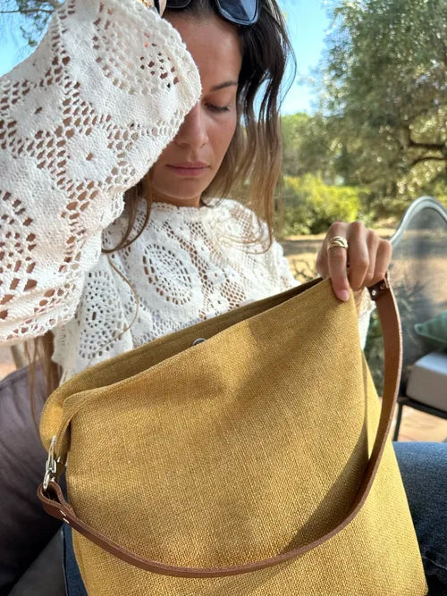 Jeune femme avec le sac Hobo en lin moutarde et son anse en cuir marron