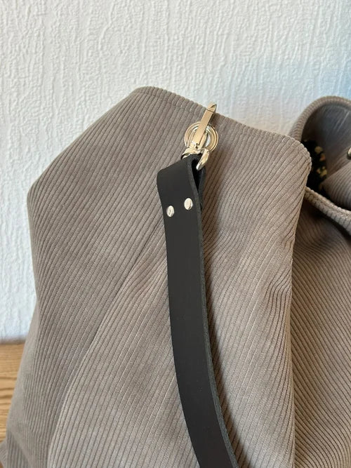 Vue latérale du sac Hobo en velours cotelé taupe.