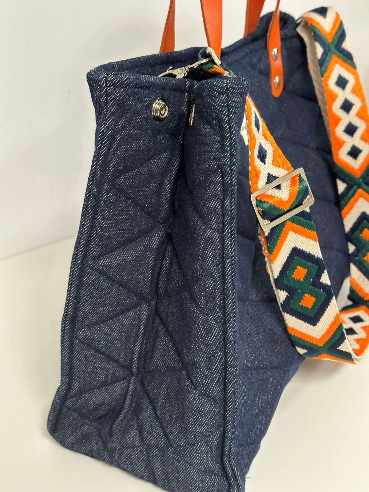 Vue latérale du sac Shopper en denim et cuir orange.